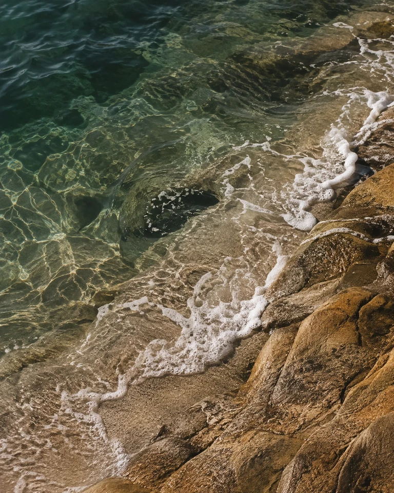 Clear green water and foam over stone, an atmospheric illustration created for Surfgear